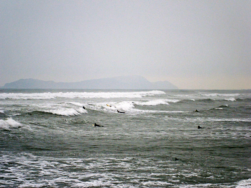 Surfers in the rough and cold Pacific.jpg