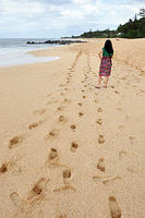 Charlotte makes footprints in the sand.jpg