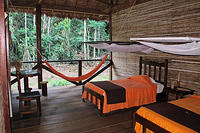 The guest rooms have one wall completely open to the jungle, your are protected by mosquito nets.jpg